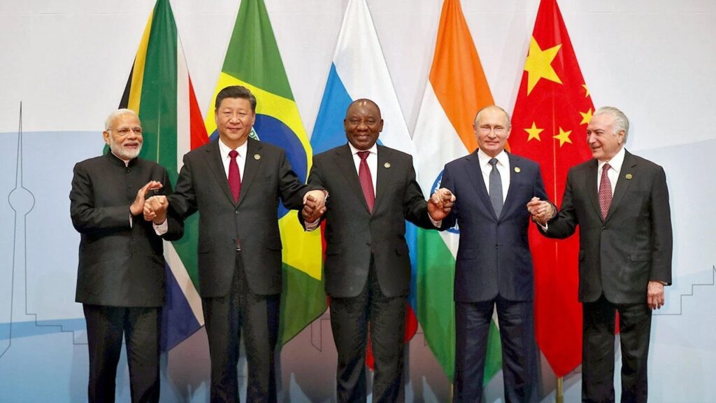 India (far left): The leader of India (often represented by the Prime Minister) is responsible for steering the country’s policies on both a domestic and international level, emphasizing growth, development, and regional stability.

China (second from left): The leader of China (often represented by the President) heads the Chinese government, focusing on economic expansion, technological advancement, and asserting China’s influence globally.

South Africa (center): South Africa’s leader (usually the President) represents Africa's economic and political interests within BRICS, highlighting issues of development and partnership with other BRICS nations.

Russia (second from right): The leader of Russia (usually the President) promotes Russia's economic, military, and geopolitical stance, especially in opposition to Western policies and in support of multipolar global governance.

Brazil (far right): Brazil’s leader (typically the President) plays a crucial role in representing Latin America, focusing on regional development and cooperation within the BRICS framework.